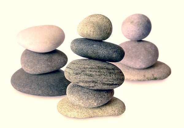 depiction of balance with zen-type stones piled atop one another